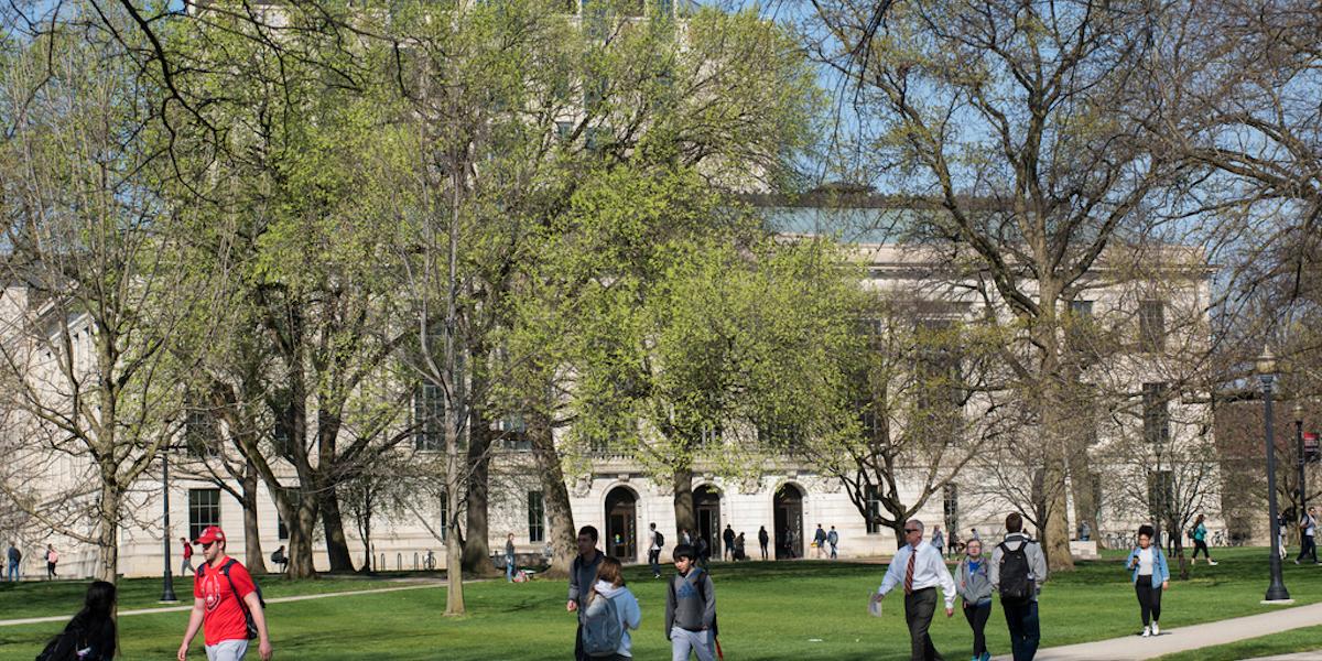 Students walk the Oval at Ohio State on a sunny day.